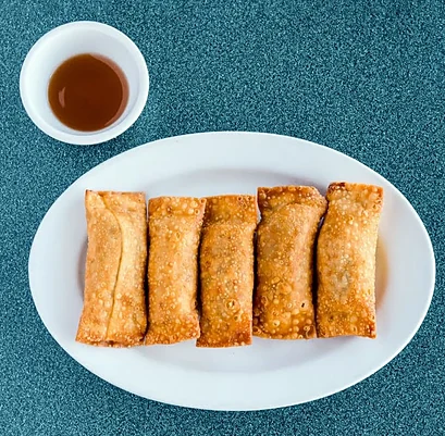 Five egg rolls with a cup of plum sauce